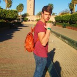 Alex with a leather bag he purchased in the Souks, and with Koutoubia Mosque behind him