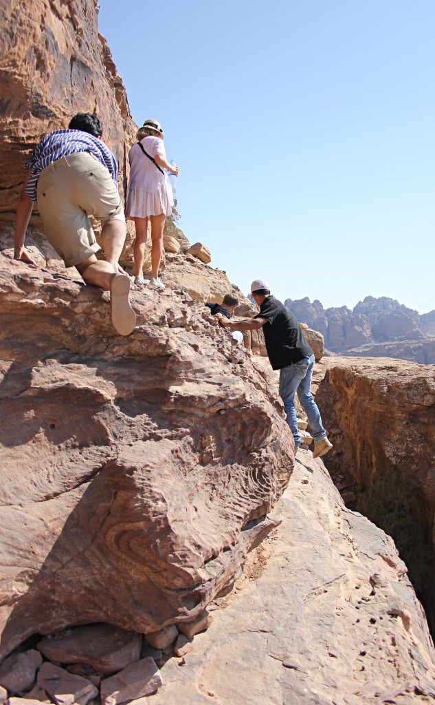 Climbing Mountain cliffs in Petra, Little Petra, Jordan, trekking
