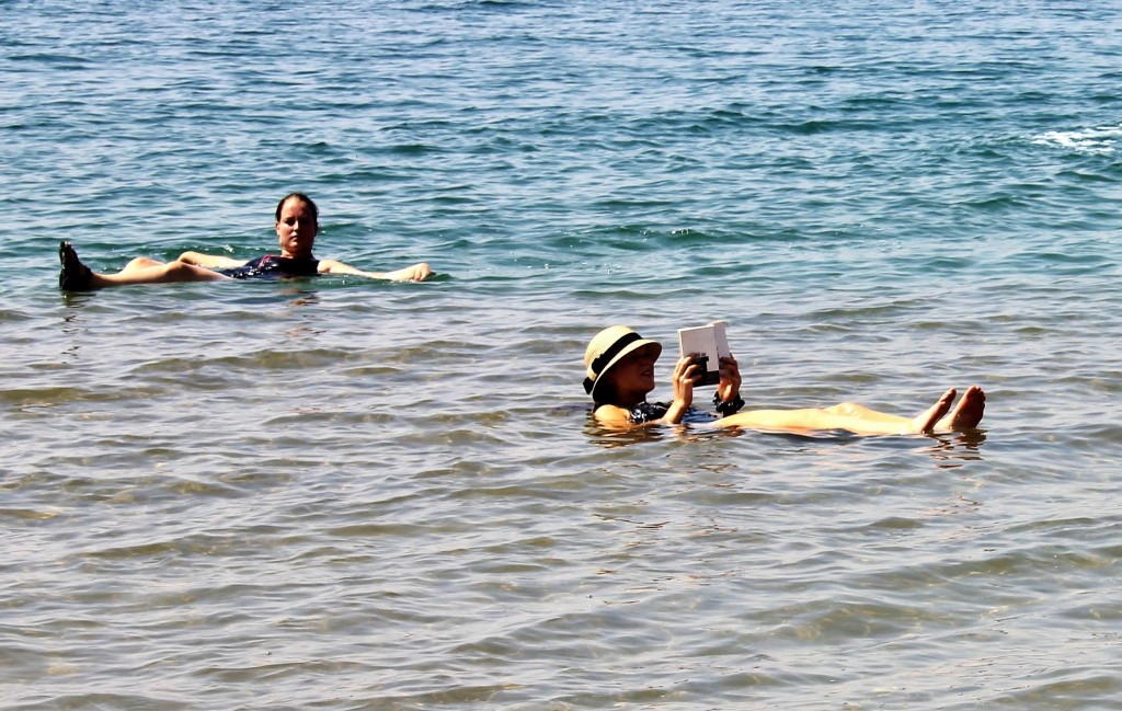 Floating and reading in the Dead Sea, Jordan.