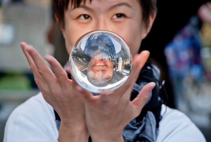 Contact juggler with crystal ball, street performer in London